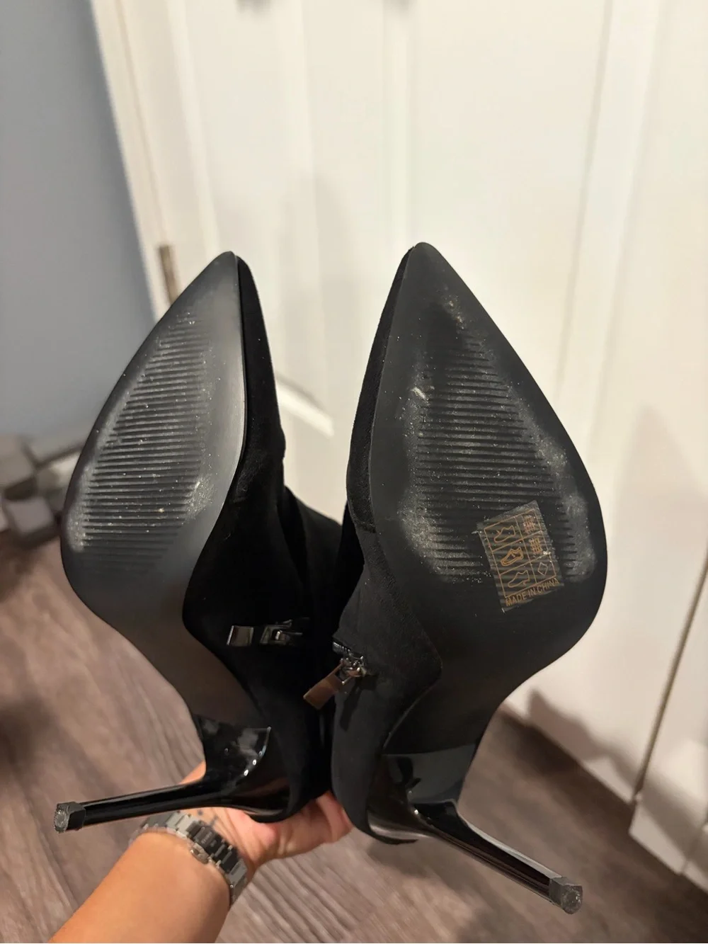 Black suede boots with pointed toe and stiletto heel